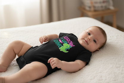 Baby wearing black Baby Creator DINO bodysuit